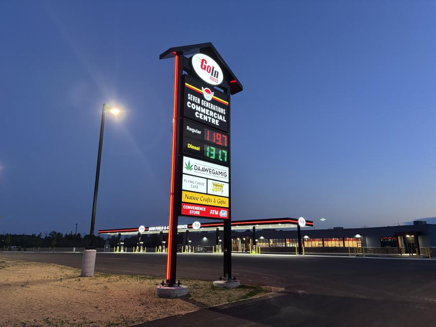 Sign outside GoIn Fuels with the names of the stores in the Commercial Centre